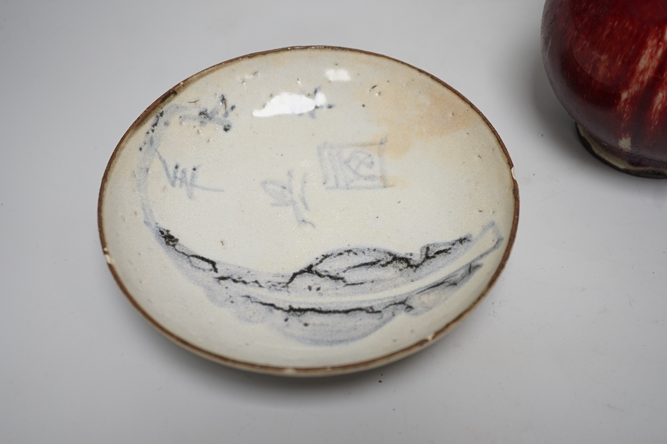 A Chinese sang de boeuf glazed bottle neck vase, together with a Chinese blue and white tea bowl, and a Chinese dish, tallest 23cm